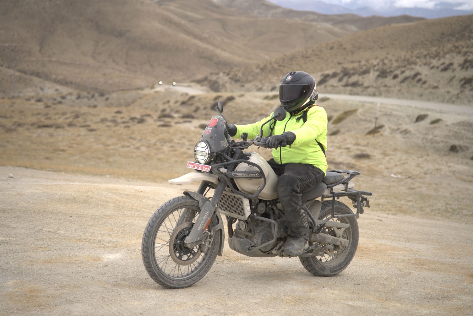 Motorycle rider on royal enfield himalayan around upper mustang